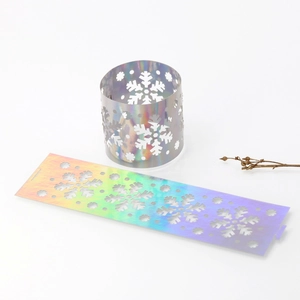 Detail of laser-cut iridescent snowflake napkin rings with mirror holographic finish