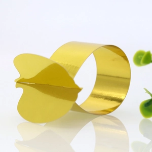 Close-up of golden pumpkin-shaped napkin ring with a polished mirror finish for table decor