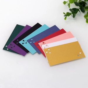 Detailed laser-cut heart seat cards in nine pearlescent colors for wedding tables