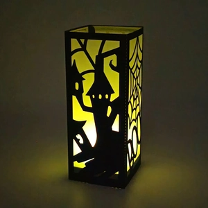 Halloween paper lantern with black castle cutout and warm yellow LED candle glow