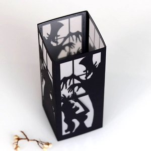 Close-up of a black paper witch lantern with spooky silhouettes for Halloween decor