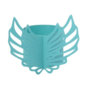 Detailed macro view of laser-cut teal angel wing paper napkin ring for wedding decor