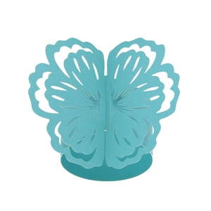 Macro view of laser-cut teal blue cardstock butterfly napkin ring for table decor