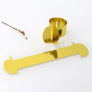 Detail view of mirror gold pumpkin-shaped paper napkin ring for Thanksgiving table decor