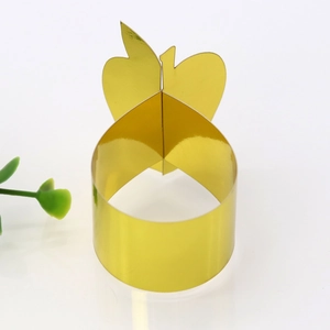 Close-up of shiny gold apple napkin ring with a mirror finish for festive table decor