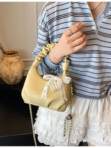 Light yellow mini crossbody bag with cloud handle and pearl lace bow detailing