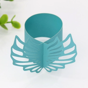 Detailed laser-cut teal paper napkin ring featuring intricate butterfly wing patterns