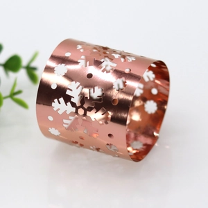 Detail of rose gold mirror finish snowflake napkin ring with laser-cut hollow pattern