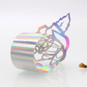 Iridescent laser cut shell pattern napkin ring with vibrant rainbow metallic finish