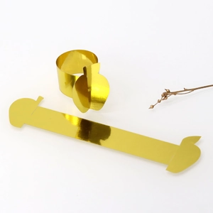 Detail view of mirror gold apple napkin ring showing polished finish and components