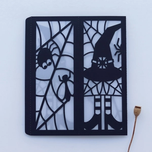 Detailed laser-cut spider web pattern on black paper Halloween lantern cover