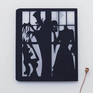 Detailed laser-cut Halloween card featuring a black witch and skull silhouette design