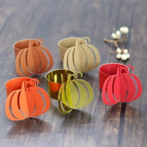 Detailed view of hollowed-out pumpkin paper napkin rings in autumn festive colors