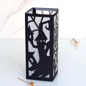 Laser-cut black Halloween paper lantern featuring a haunted castle and spider web detail