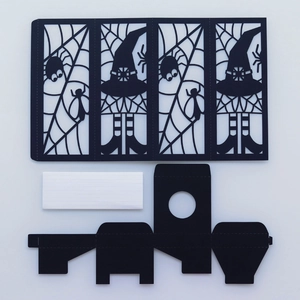 Laser-cut Halloween paper lanterns with spider web and witch hat patterns
