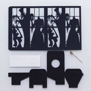 Detail of Halloween DIY paper lantern kit with black laser-cut vampire and skull silhouettes