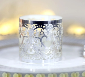 Detailed view of silver hollow laser-cut heart and floral lace patterns for decorations