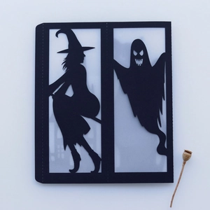 Detailed laser-cut black Halloween paper card featuring witch and ghost silhouettes