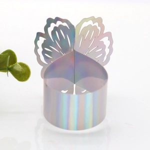 Macro detail of laser iridescent butterfly napkin rings with hollow paper carving effect