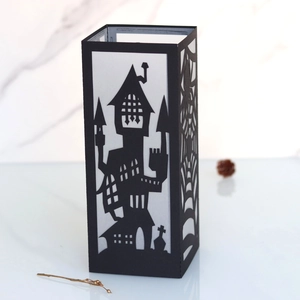 Detail of Halloween black lantern featuring laser-cut spider web and spooky castle motifs