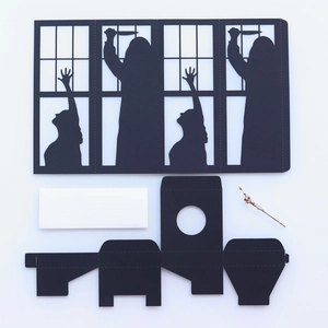 Flat lay macro of Halloween black witch silhouette paper card and craft kit tools