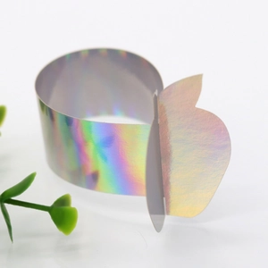 Macro shot of laser-cut iridescent butterfly napkin ring with rainbow reflective finish