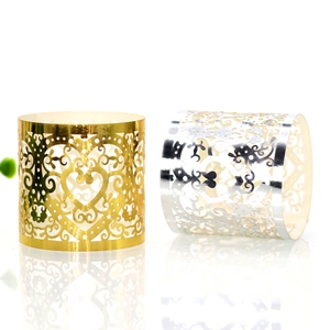 Detailed laser-cut heart pattern on gold and silver napkin rings with elegant scrollwork