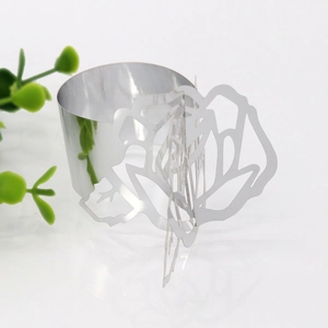 Close-up of laser-cut rose hollow napkin ring in silver finish for wedding tables