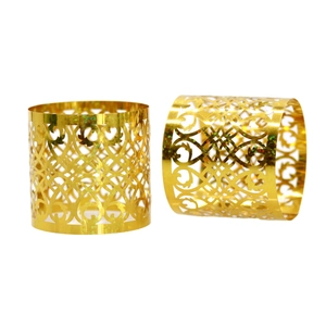 Golden hollow floral carved napkin rings with elegant filigree design for weddings