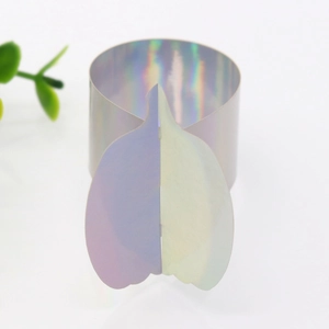 Macro detail of iridescent laser paper pumpkin napkin ring with holographic mirror finish