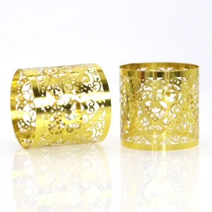 Detail showing elegant gold hollow heart napkin rings with intricate floral patterns