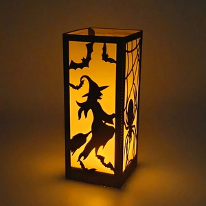 Black Halloween cutout lantern with witch and bat designs and warm glowing LED light