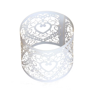 Detail of white laser-cut heart and vine pattern napkin ring made of pearlescent paper