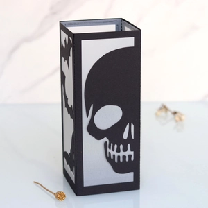 Detail view of a Halloween paper lantern with skull pattern and bat silhouettes