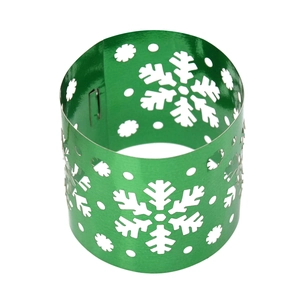 Macro detail of metallic green snowflake napkin ring with intricate laser-cut hollow design