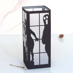Detailed laser-cut Halloween paper lantern featuring ghost and female silhouettes