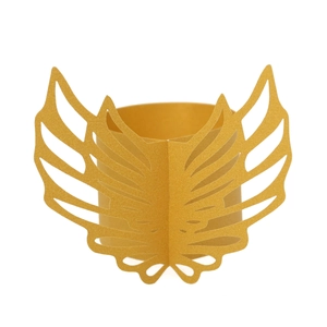 Detail of laser-cut golden paper napkin ring featuring an intricate angel wing design