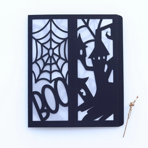 Detailed laser-cut Halloween card featuring a spiderweb, BOO text, and haunted castle