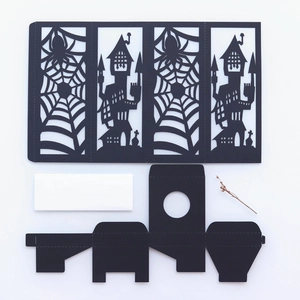 Laser-cut Halloween paper lantern set with black spider web and haunted castle patterns