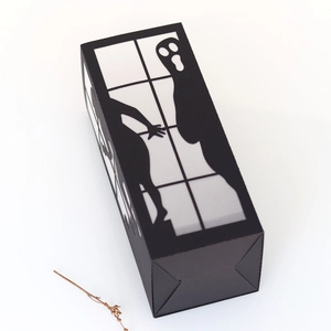 Detail view of Halloween black hollow paper lantern with ghost and figure silhouettes