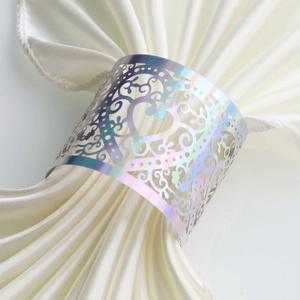Detailed holographic napkin ring featuring laser-cut heart and floral patterns on white satin