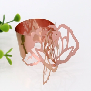Detailed view of rose gold hollow rose napkin ring with a polished mirror finish for wedding