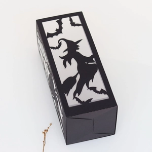 Detail view of Halloween paper lantern with intricate laser-cut witch and bat patterns