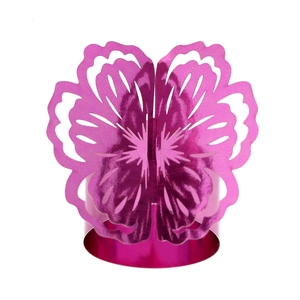 Macro detail of rose red laser-cut flower napkin ring with reflective finish