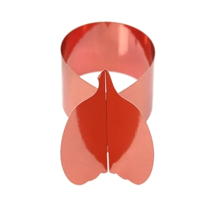 Detail of red glossy pumpkin shaped napkin ring made of reflective decorative material