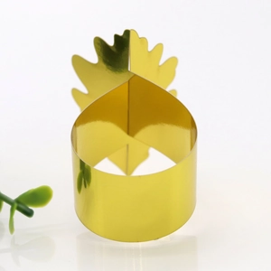 Détail d'un rond de serviette doré en forme d'ananas avec finition miroir pour fêtes
