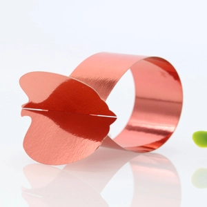 Macro view of mirror rose gold napkin ring in leaf shape with metallic finish