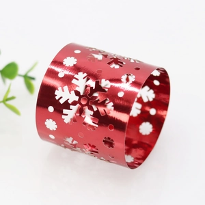 Detail of red hollowed snowflake paper napkin ring with glossy mirror finish surface