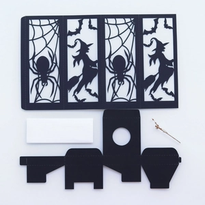 Detail of Halloween black paper cutout featuring witches, spiders, and bats for DIY decor