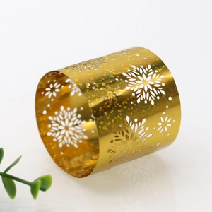 Macro shot of a golden hollow snowflake napkin ring with holographic glitter detailing
